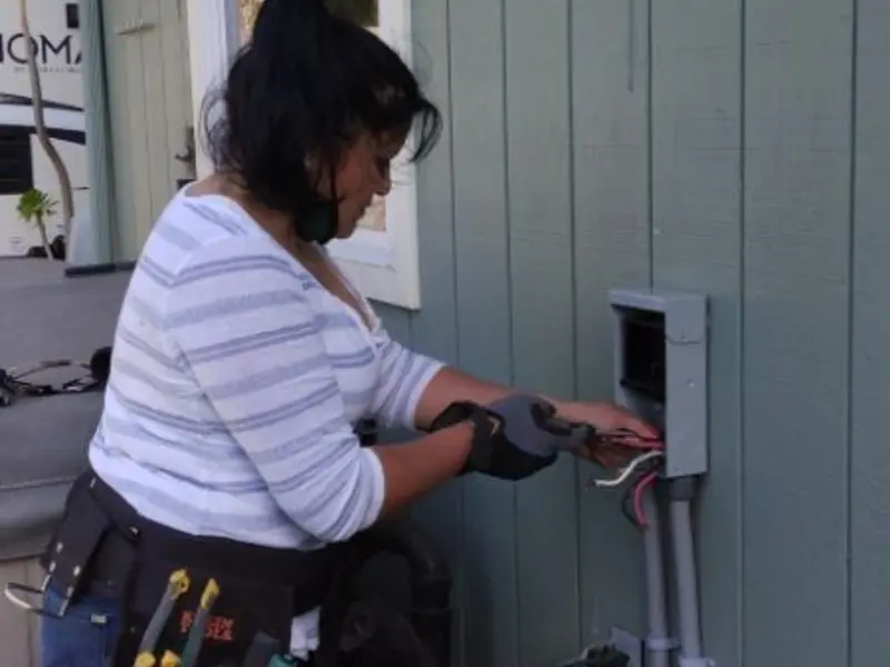 Licensed electrician wiring an exterior subpanel in Dennis