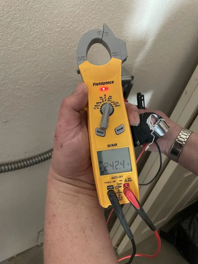 Voltage testing with clamp meter during Recessed Lighting Installation in Dennis